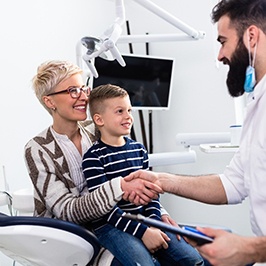 A mother and her son shaking hands with the pediatric sedation dentist in Denver 