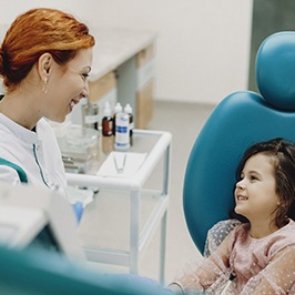 Little girl smiling at dental professional during appointment