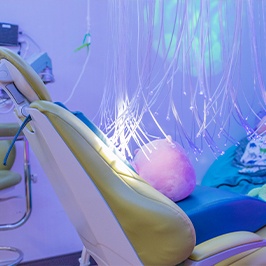 Little girl in dental chair giving thumbs up