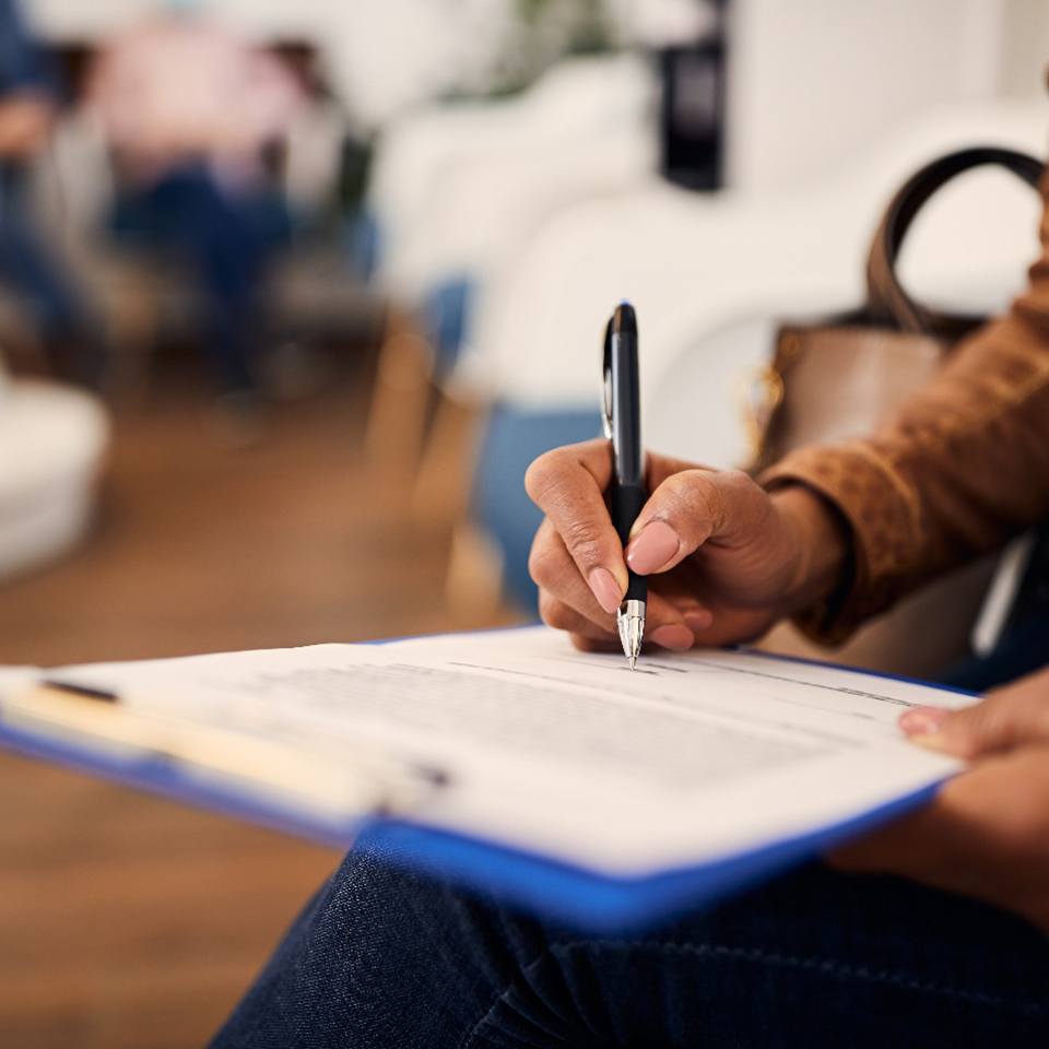 woman filling out insurance paperwork
