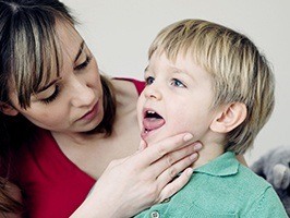 Mother looking in child's mouth