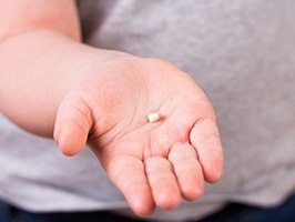 Hand holding a knocked out tooth