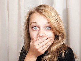 Teen covering mouth