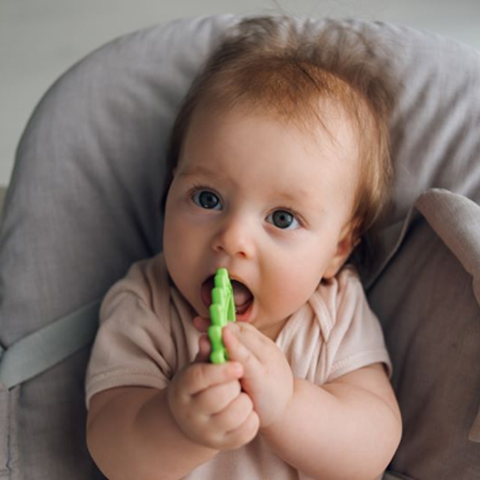 Baby holding teething ring