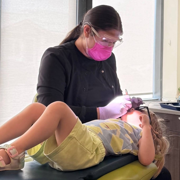 Smiling young girl with her dentist