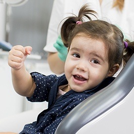 Little girl in dental chair smiling