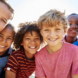 A group of children showing off their healthy smiles after visiting a pediatric dental practice that offers emergency dentistry for kids in Wash Park