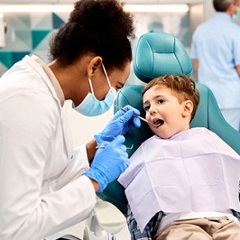 dentist examining a young child’s mouth