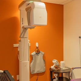 Smiling child with dentist looking at x-rays