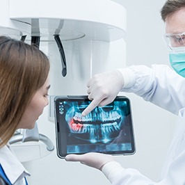 dentist showing teen girl her digital X-rays
