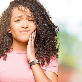 sad teen with tooth pain