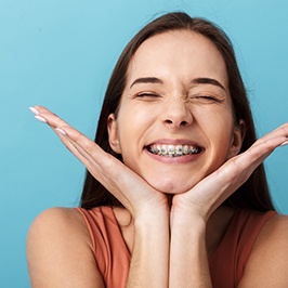 smiling teen with her eyes closed and braces