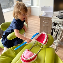 Smiling child playing with toys