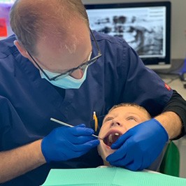 Dentist treating young dental patient