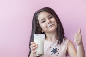 little girl enjoying milk