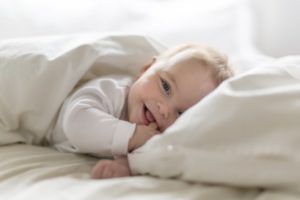 a baby playing on a bed