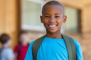 child smiling after getting dental sealants