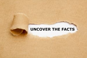 paper torn with the words “uncover the facts” underneath