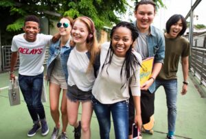 group of teens smiling and walking together