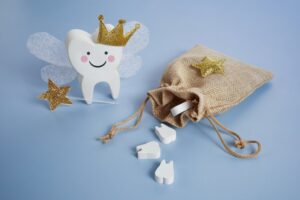 crafted Tooth Fairy figurine with a bag of teeth