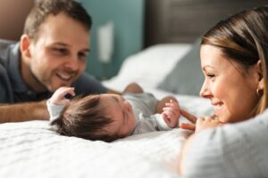 smiling parents around their newborn
