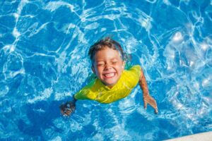 child smiling in the pool