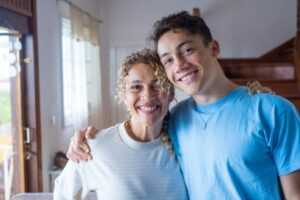 mom and teen boy smiling together