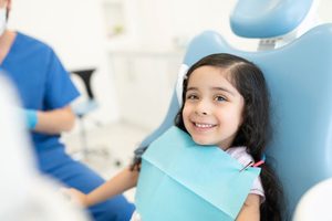 Happy little girl in dental treatment chair